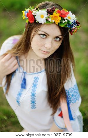 Girl With Freckles On Her Face In A Ukrainian Shirt And Floral Bouquet On The Head