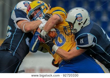 ST. POELTEN, AUSTRIA - JUNE 1, 2014: WR Marcus Johnsson (#88 Sweden) is tackled by DB Juhani Koivumaki (#36 Finland).