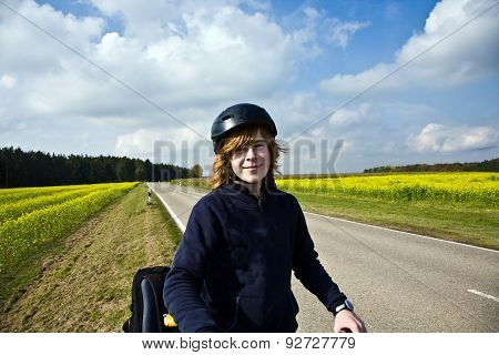 Young Boy On His Mountain Bike Is On A Bicycle Tour Along Beautiful Countryside