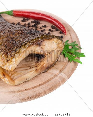 Fried carp tail with pepper and parsley.