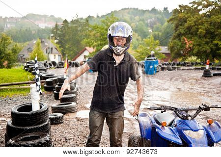 Young Boy Is Faszinated By Quad Driving And Enjoyes Is, His Face Is Dirty From Mud