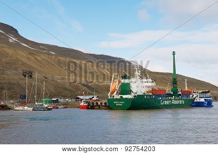 Cargo ship unloads at the harbor of Longyearbyen in Longyearbyen, Norway.