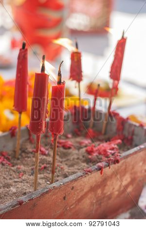 Burning Candle In Pot At Chinese Shrine.