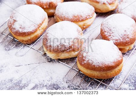 German donuts - berliner with icing sugar on a dark wooden table