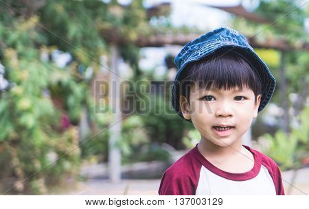 happy Japanese boy in a farm garden.