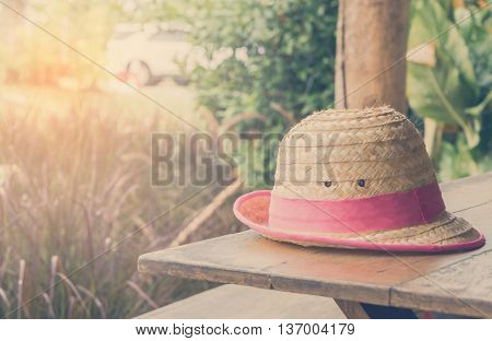 straw Farmer Hat on table vintage tone.