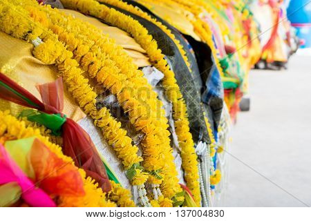 Colorful Buddhism flower garlands on spiritual tree.