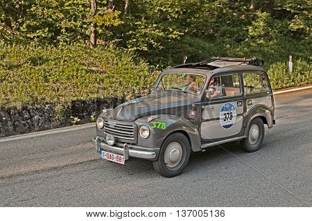 PASSO DELLA FUTA (FI) ITALY - MAY 21: driver and co-driver on a vintage Fiat 500 C Topolino Belvedere (1955) in historical classic car race Mille Miglia on May 21, 2016 in Passo della Futa (FI) Italy