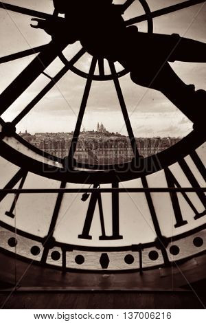 City view through Giant clock tower in Paris, France.