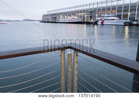 Boston, Massachusetts, USA - March 17, 2016: Misty morning on Boston Harborwalk looking toward Commonwealth Pier