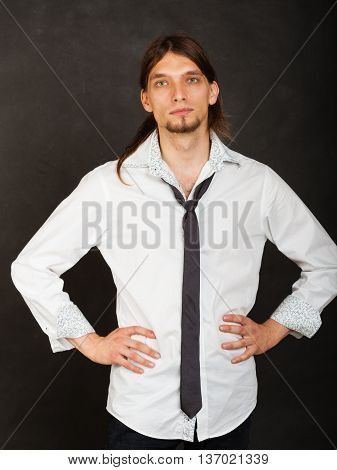 Masculinity fashion concept. Man in shirt and tie. Young long haired male on dark background.