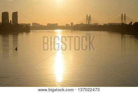 Cable stayed bridge and Neva river on the outskirts of St. Petersburg at sunset Russia.