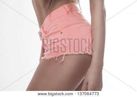 Sexy woman body in jeans shorts. The model is back. Great ass. Studio shot on white background.