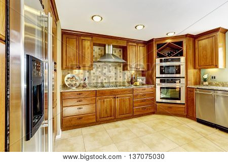 Luxury Kitchen With Tile Floor And Stained Cabinets