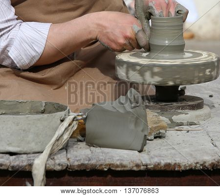 Potter With The Hand Lathe During Production Of A Pot With Clay