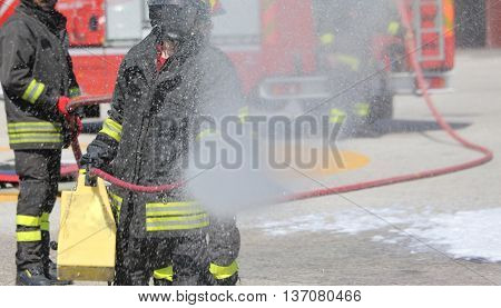 Firemen With The Fire Extinguisher During A Practice Session