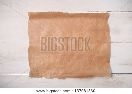 Cooking paper sheet on wooden board 
