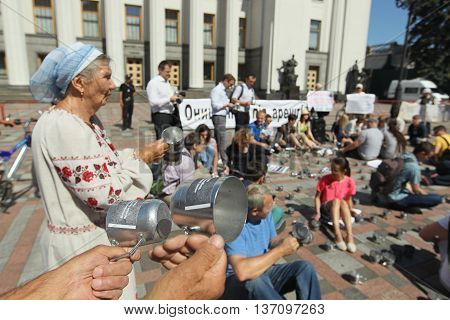 Kiev Ukraine - July 5 2016: Public activists rattling the cups of prison to parliament voted for arrest an escaped politician Alexander Onishchenko in Russia near the building of the Verkhovna Rada of Ukraine