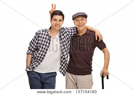 Senior man pranking his grandson with bunny ears isolated on white background