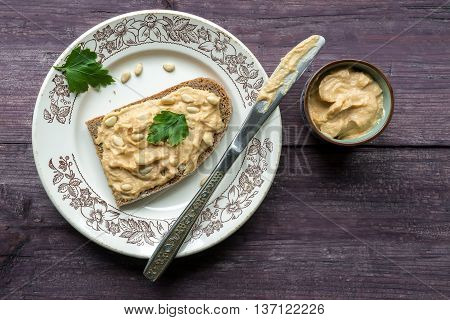 Hummus toast on wooden table. Top view