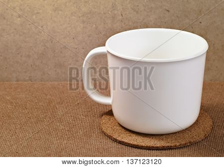 White plastic cup on wooden serving tray
