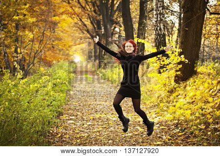 Young woman in the forest. Autumn in Poland.