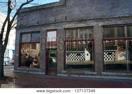 JOLIET, ILLINOIS / UNITED STATES - NOVEMBER 1, 2015: A vacant brick building formerly housed a furniture store in downtown Joliet.