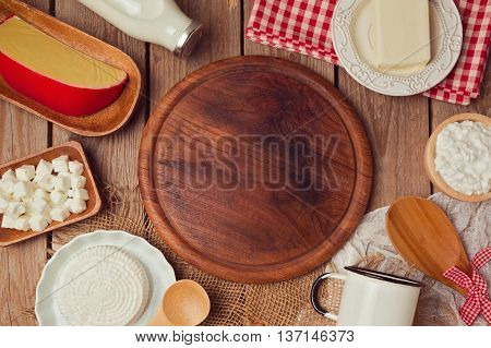 Wooden board with milk and cheese. Place for text. Healthy eating concept. View from abobe. Flat lay