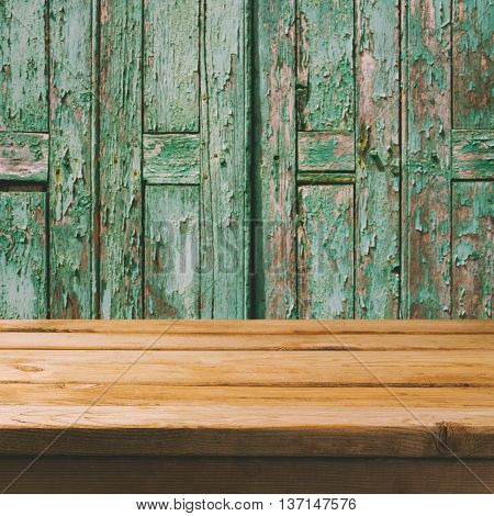 Empty wooden deck table over old wooden boads background