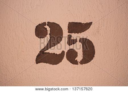 The number twenty five painted on the wall