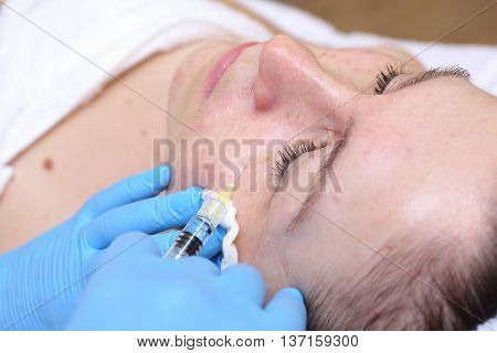 Anti-age injection therapy. Mimic wrinkles reduction in clinic