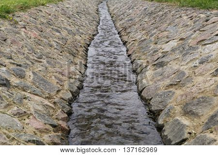 the stream leaving afar is protected with stones
