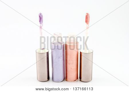 Two tubes of lip gloss isolated on white background