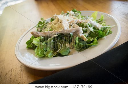 Fresh organic caesar salad with grated asiago cheese