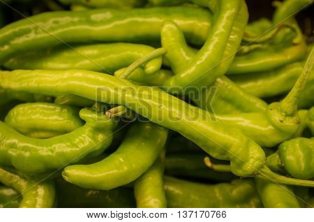 Spicy organic cubanelle chili peppers on display at local farmers market