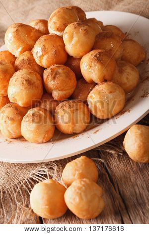 Greek Loukoumades Donuts With Honey And Cinnamon Closeup. Vertical