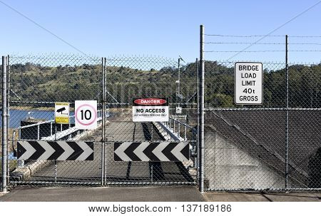 LAKE BAROON, AUSTRALIA - July 3, 2016: View of a shut gate and multiple warning signs on July 3, 2016 in Lake Baroon, Australia
