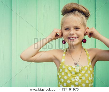 Beautiful girl holding cherries as earrings -style Rockabilly. Space for text