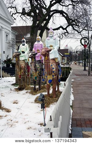 PLAINFIELD, ILLINOIS / UNITED STATES -DECEMBER 29, 2015: The Three Wise Men ride their camels in a nativity scene standing outside of the Plymouth Congregational Church in downtown Plainfield.