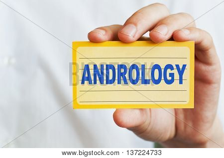 Andrology concept. Card with text in doctor hands