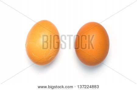 Couple of Eggs isolated on white background. One of them is cracked.