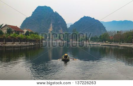 A lone boat man on the Ngo Dong river in Tam Coc near Hanoi- Vietnam.