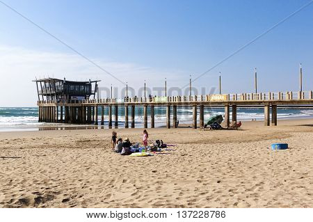 People And Vetchs Pier Against Sea And Skyline