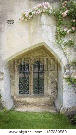 LACOCK ABBEY, LACOCK, WILTSHIRE, UK, 21 JUNE 2016 - Unusual shaped medieval window at Lacock Abbey Lacock Wiltshire UK