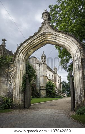 LACOCK ABBEY, LACOCK, WILTSHIRE, UK, 21 JUNE 2016 - View of the abbey through the arch