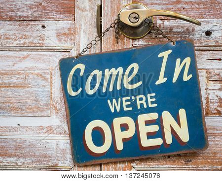 Come In We're Open on the wooden door retro vintage style