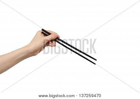 left hand holding chopsticks on white background.