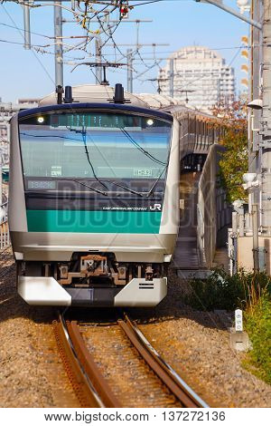 TOKYO, JAPAN - NOVEMBER 29 2015: A local  train arrives at Ikebukuro station