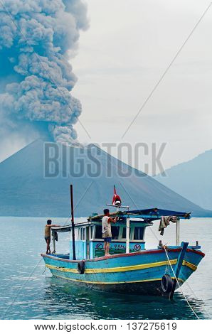 INDONESIA - JANUARY 20: Boat near volcano Anak Krakatau during eruption on January 20 2011.