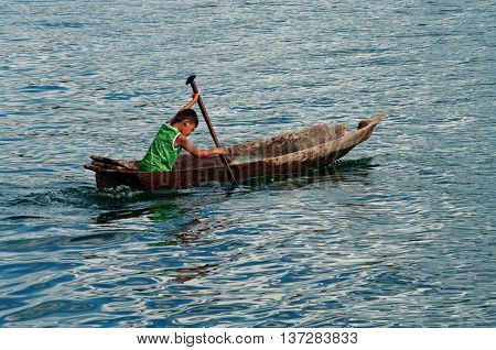 SAMOSIR INDONESIA - AUG 05 : Local boy on the fishing boat Aug 05 2011 on lake Toba near island Samosir Sumatra Indonesia.
